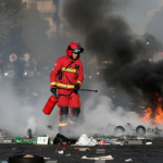 Firefighter amidst smoke and debris.