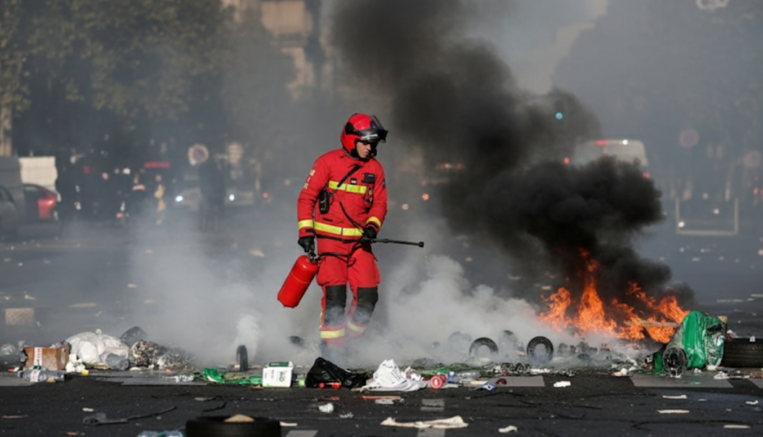 Firefighter amidst smoke and debris.