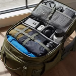 A neatly packed travel backpack with essential gadgets like a power bank