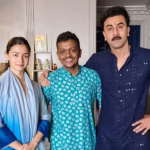 Alia Bhatt and Ranbir Kapoor posing with staff