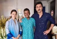 Alia Bhatt and Ranbir Kapoor posing with staff