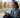 Young woman looking contemplative with a phone, showing emotions subtly