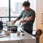 Stressed parent multitasking in modern kitchen