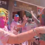 Foreign tourists immersed in the native colors of Holi.